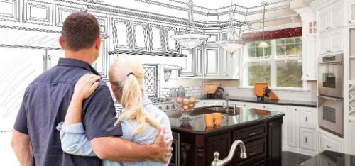 Couple standing in kitchen imagining their remodel.