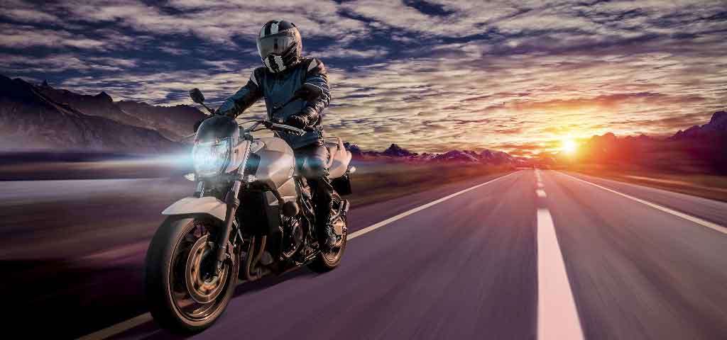 Motorcycle Loan Driving at sunset