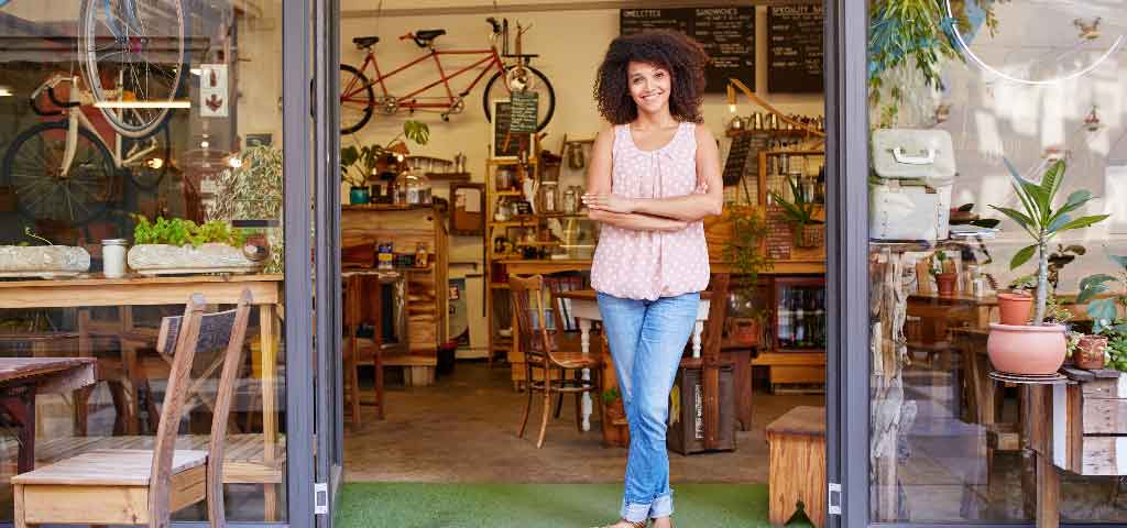 Girl standing in business doorway.