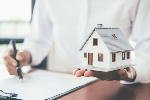 mortgage writer holding small house